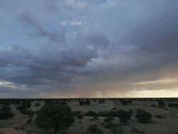 Timelapse heavy cloud over desert, dusk to sunset, Kalahari, South Africa Stock Footage