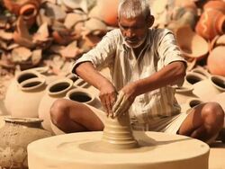 Senior man making a earthen pot on a pottery wheel, Faridabad, Haryana, India Stock Footage