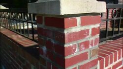 Wrought iron railings decorate brick columns. Stock Footage