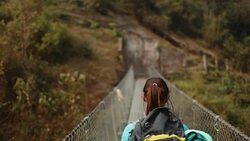 Hiker girl crossing the bridge Stock Footage