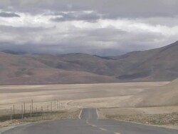 Pull back reveal Highway with vehicles Taklakot Tibet China Stock Footage