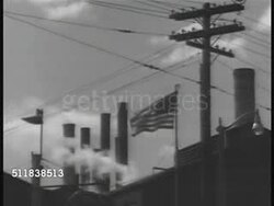 1941: US INDUSTRY: Two men working on engines in factory. WS American flag on pole above factory. WARTIME ETHNIC BIAS: CU Sign in window 'Only Native Born Americans Need Apply'   WWII, National Security, Racism, Ethnocentricity, pre-Pearl Harbor. Instructional Video