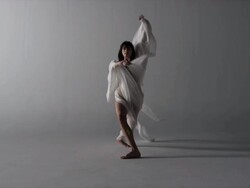 woman draped with silk walks elegantly towards camera Stock Footage