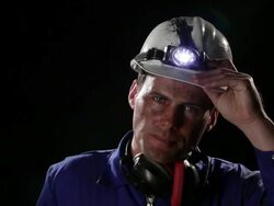 CU, Lockdown, Coal miner removing hardhat and wiping sweat off his upper lip Stock Footage