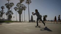 dolly of skater filming himself with phone venice California skatepark Stock Footage