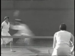 Professional tennis player Helen Wills returns balls in a doubles tennis match. Stock Footage