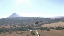 A helicopter flies over a game reserve in South Africa. Stock Footage