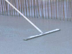 Worker Smoothing Concrete on Constrution Site Stock Footage