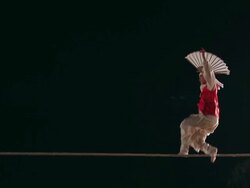 MS Shot of tightrope walker doing acrobatics on high wire at night / Gyeonggido, South Korea Stock Footage