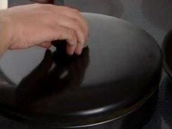 Two pans on cookstove, one with egg omelette Stock Footage