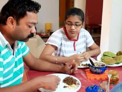 Indian father and daughter having breakfast together Stock Footage