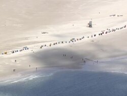 MS AERIAL ZO View of people at coast of North Sea / Amrum, Schleswig Holstein Stock Footage