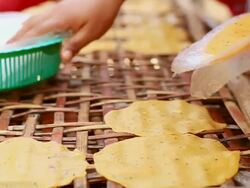 CU SLO MO Shot of woman putting cassava crackers on bamboo panel / Luang Prabang, Laos Stock Footage