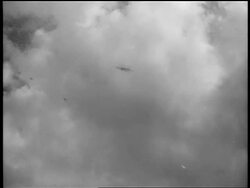 B/W 1939 low angle German fighters swooping down in sky over Warsaw, Poland / documentary Stock Footage