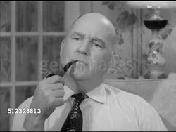 1952: JOHN DAVY NEWS OF THE MOMENT: VS Male (middle age) & female (wife) sitting in living room, watching television, male adjusting dial, smoking pipe. VS John Davy speaking (SOT) about U.S. Presidential campaign between Eisenhower & Stevenson. Instructional Video