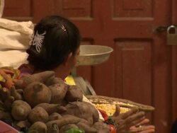 "CU of woman at market stall talking, with fresh produce in f/g,  Chachapoyas market, Chachapoyas, Peru [PerÃƒÂº]" Stock Footage