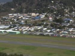 WS AERIAL ZI View of Gold Beach bridge with houses / Oregon, United States Stock Footage