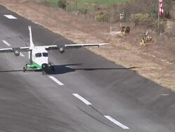 MS TS Prop Aircraft flying and landing on small Runway of Lukla Airport near Khumbu Valley / Lukla, Khumbu Region, Nepal Stock Footage