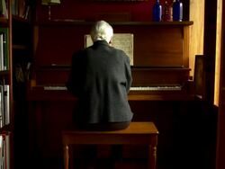 Slow dolly out on woman playing piano. Stock Footage