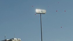 Football stadium lights shine as balloons float into the sky. Stock Footage