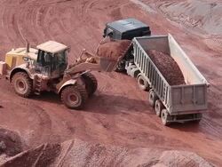 MS Crane putting mud in other truchk in  quarry / Taben-Rodt, Hesse, Germany  Stock Footage