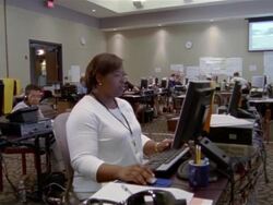 September 2005 Wide shot pan volunteers working on computers at Hurricane Katrina relief command center / Alpharetta, Georgia Stock Footage