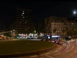 W/S Barcelona, traffic trails and traffic lights, roundabout, full moon Stock Footage