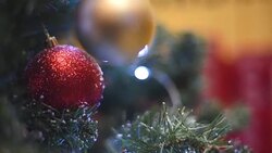 Christmas decorations on the Christmas tree with festive garland. Stock Footage