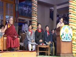 WS Woman at podium addressing attendants of Dalai Lama's 70th birthday AUDIO / Dharmasala, Himachal Pradesh, India Stock Footage