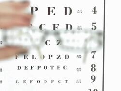 HD: Glasses Against An Eye Chart Stock Footage
