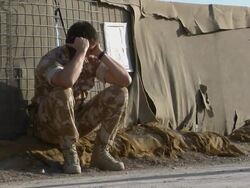 WS Soldier using walkie-talkie, rubbing eyes / Musa Qala, Helmand Province, Afghanistan. Stock Footage