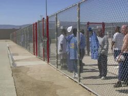 WS Female officer letting  prisoner go inside prison yard at California state prison in Los Angeles country / Lancaster , California, USA Stock Footage