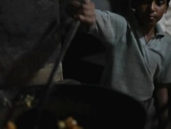 MS TD Young boy cooking fried food / India Stock Footage