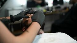 Close-up of beautiful attractive adult man with beard in a barber shop Stock Footage