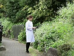 MS Woman inspecting  plants with measuring instrument / Shibuya, Tokyo, Japan  Stock Footage
