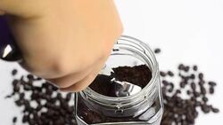 scoop coffee grind from a transparent bottle Stock Footage