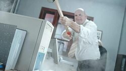 SLO MO Enraged business man destroying computer with hammer Stock Footage