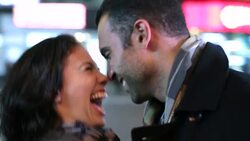 Young woman kisses boyfriend on cheek and laughs beneath the lights of Times Square Stock Footage