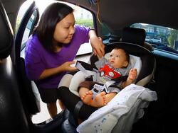 HD:Mother take care her baby on seat belt. Stock Footage