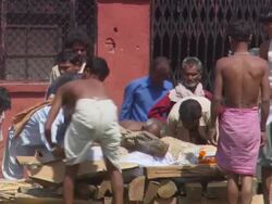 MS TU PAN Men place Kindling over dead body in preperation for burning ritual  AUDIO / Kathmandu, Central Region, Nepal Stock Footage