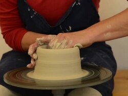MS Shot of female potter shapes pitcher from lump of clay on potterwheel at pottery / Landshut, Bavaria, Germany Stock Footage