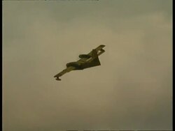 MS Aeroplane dumping water, as it circles over bushfire Stock Footage