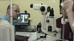 Optometrist talks to nurse and gives her patient's medical record Stock Footage