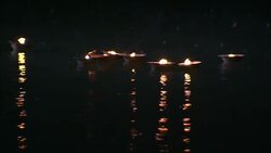 Flickering diyas float on a river during a Diwali celebration in India. Stock Footage