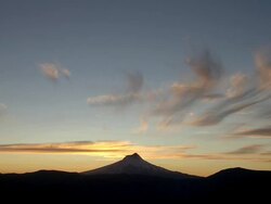 Mount Hood silhouetted against golden sunset and clouds Stock Footage