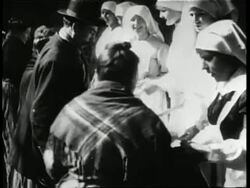 Europeans and their families eat at an outdoor soup kitchen at the end of World War One. News Clip