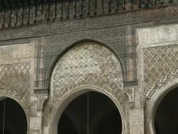 MS Shot of ornate keyhole door frames in Madras Bou Inania / Fez, Fes-Boulemane, Morocco Stock Footage