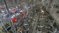 Robots weld and assemble in an automotive factory. Stock Footage