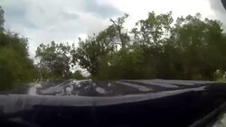 POV from a truck driving through large puddles in the jungle Stock Footage