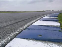 Low angle medium shot Formula One race car speeding around curve Stock Footage